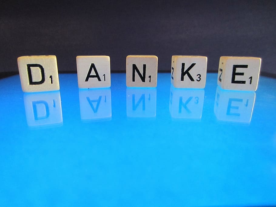 DANKE dice on glass surface, thank you, letters, cube, word, font