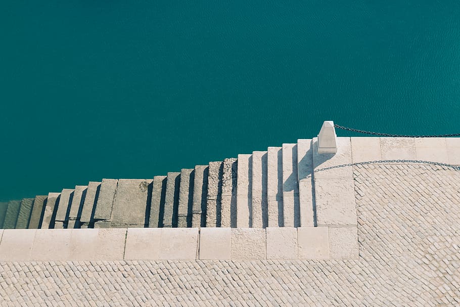 white concrete stairs near body of water, aerial photography of white concrete staircase beside body of water during day, HD wallpaper