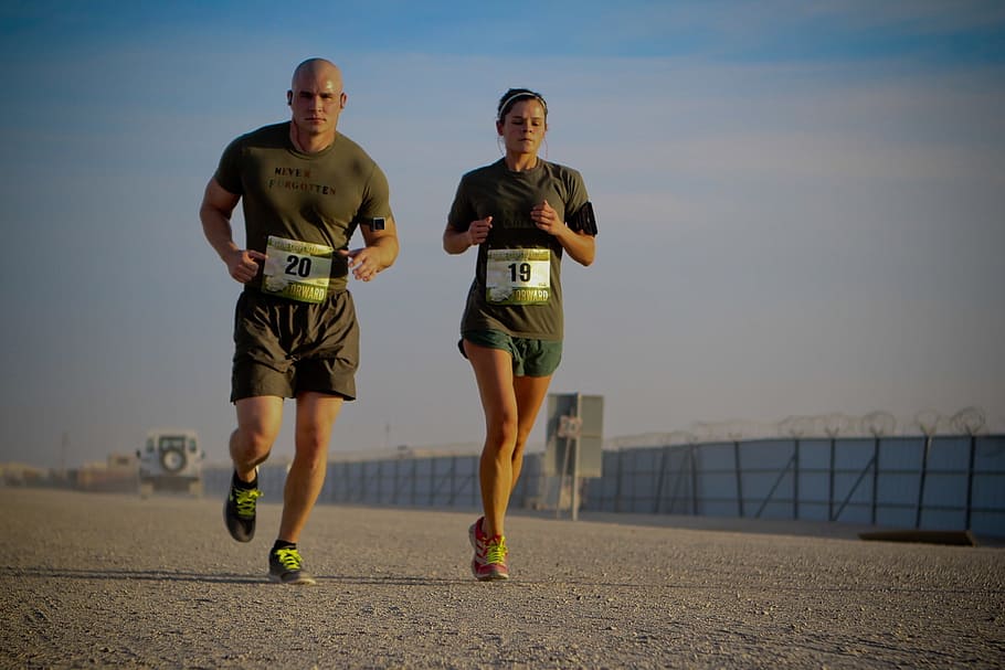man and woman in green shirt and shorts running during daytime, HD wallpaper