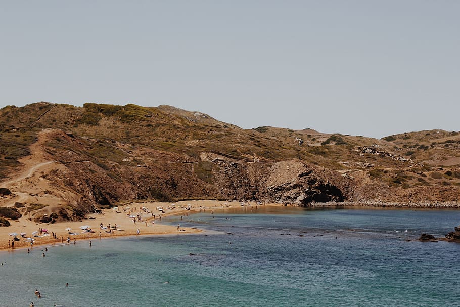 people near seashore swimming and standing during daytime photography, body of water HD wallpaper