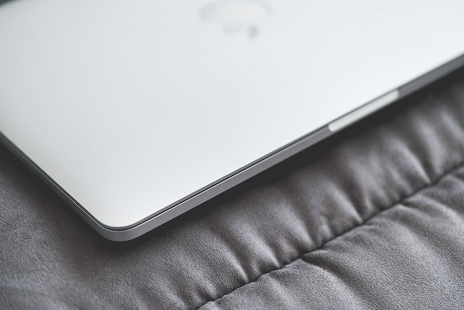 Closed Macbook Laptop on a Sofa #2, apple, black and white, business HD wallpaper