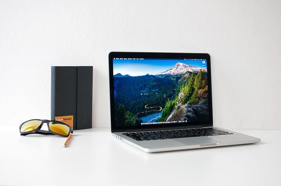 MacBook Pro beside black framed sunglasses, webdesign, notebook HD wallpaper
