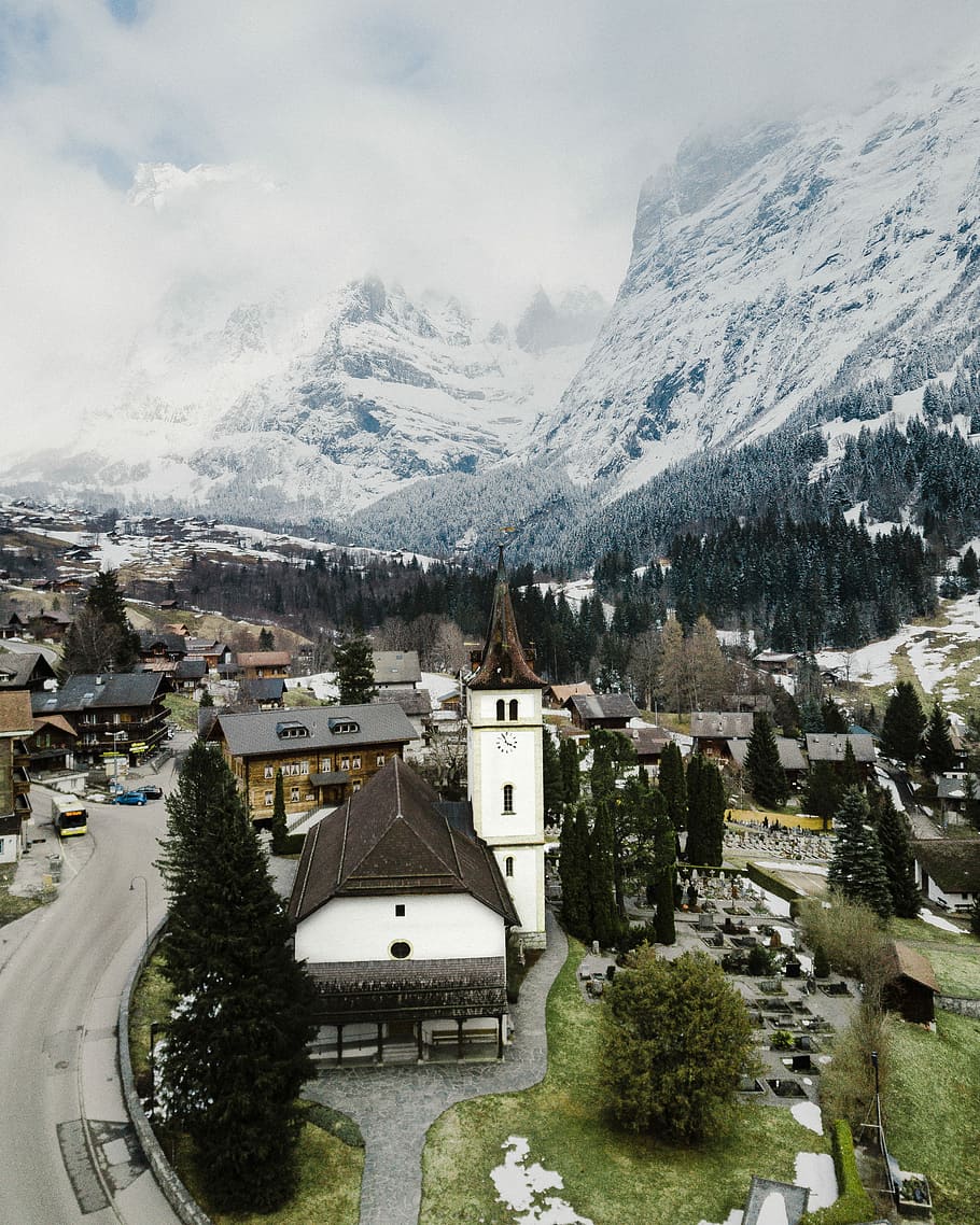 aerial view of village, concrete houses near ice-capped mountain at daytime HD wallpaper