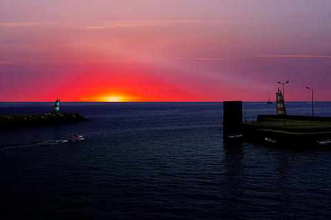 blue ocean water under sunset, white and red boat on body of water during sun set HD wallpaper