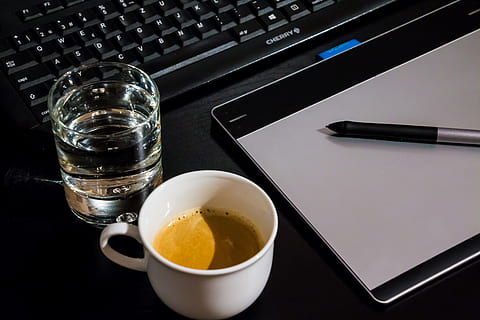flat lay photograph of clear drinking glass, white ceramic cup, and Wacom Intuos graphics tablet HD wallpaper
