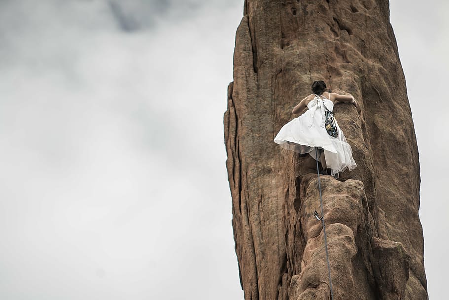 low angle photography of bride climbing rock formation, ancient HD wallpaper