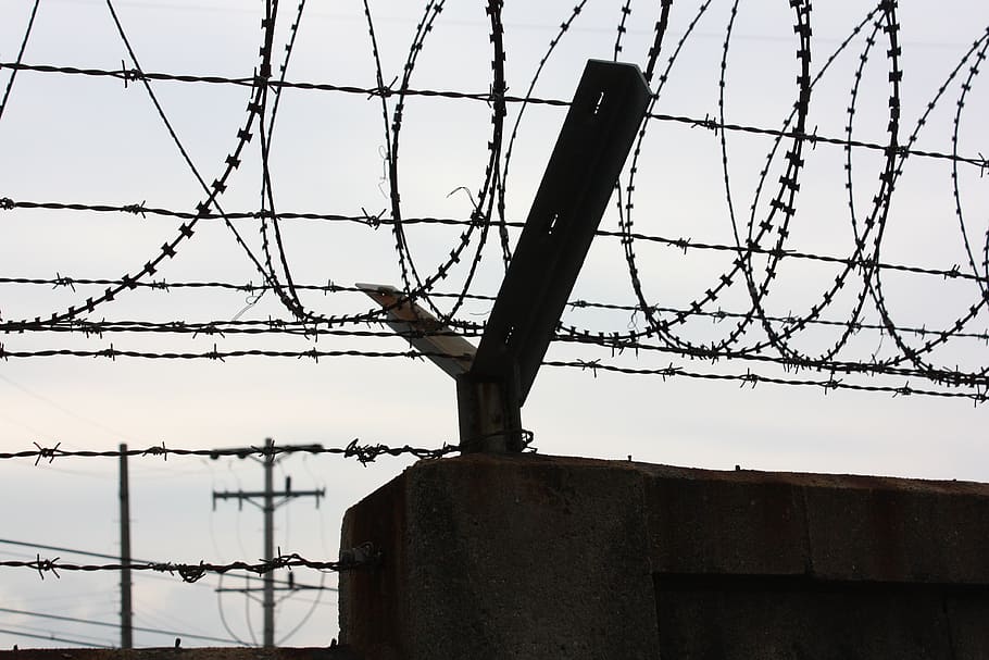 barbed wire, wall, shade, sky, shadow, barrier, fence, metal