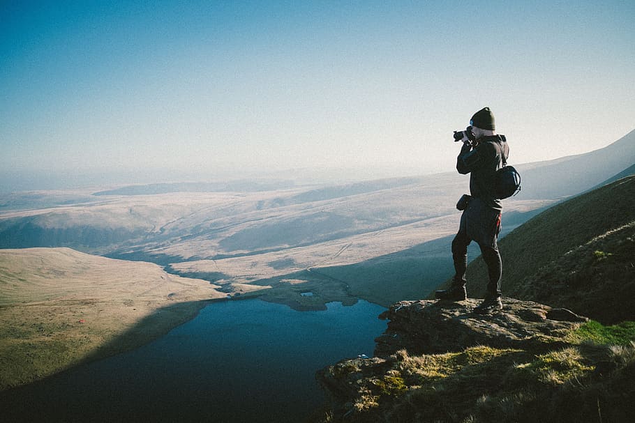 standing man taking photo of water and land, people, guy, alone HD wallpaper