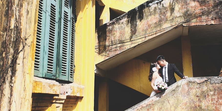 man and woman standing on building, hanoi, couple, wedding, old