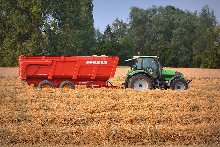 green and black tractor with red trailer on grass field, straw HD wallpaper
