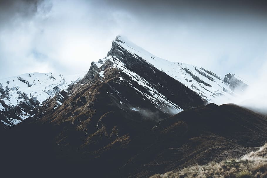 landscape photography of grey mountain, mountain covered with snow and fogs during daytime HD wallpaper