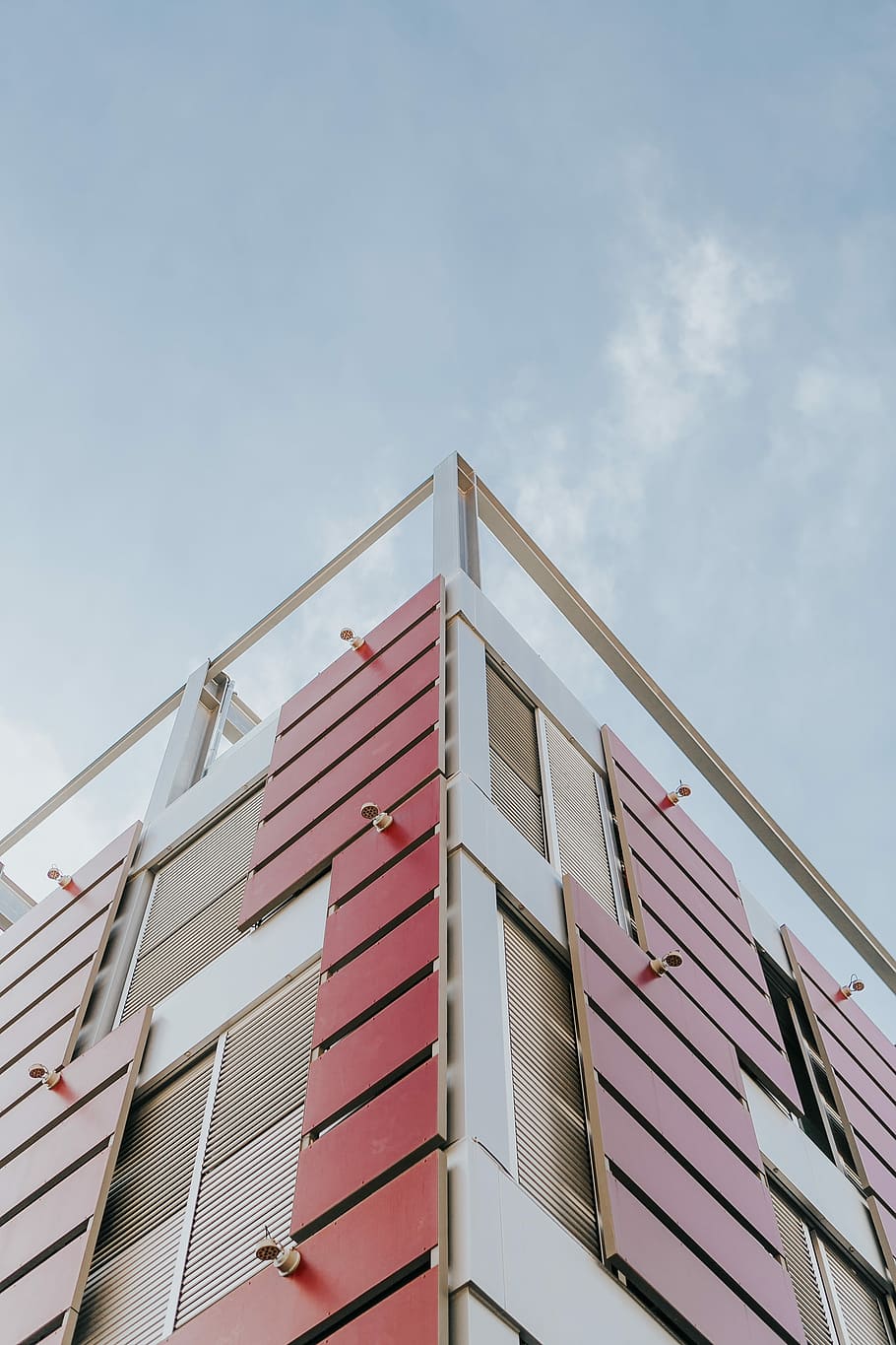 low-angle photography of red and beige concrete building at daytime, low angle photography of white and red building HD wallpaper