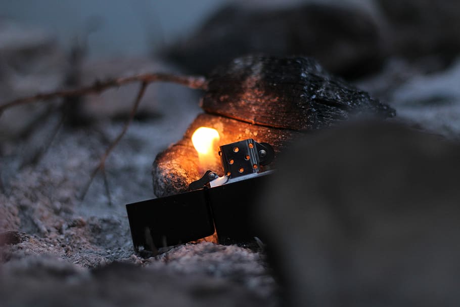 closeup photo of lighted black flip lighter, black flip-top lighter burning wood HD wallpaper