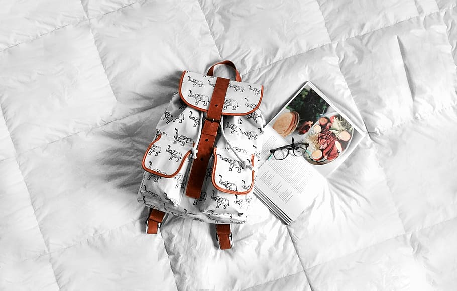 backpack, bed, book, eyeglasses, white, bedroom, high angle view HD wallpaper