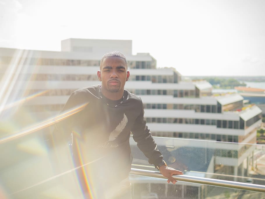 man in black long-sleeved shirt standing near glass handrails, photo of man wearing black shirt near at terrace railings HD wallpaper