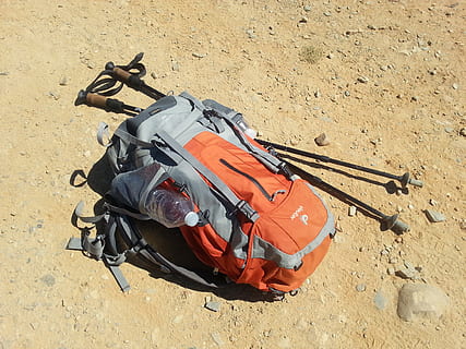 Hd Wallpaper Orange And Gray Backpack Beside Two Climbing Sticks Lying On Brown Ground Wallpaper Flare