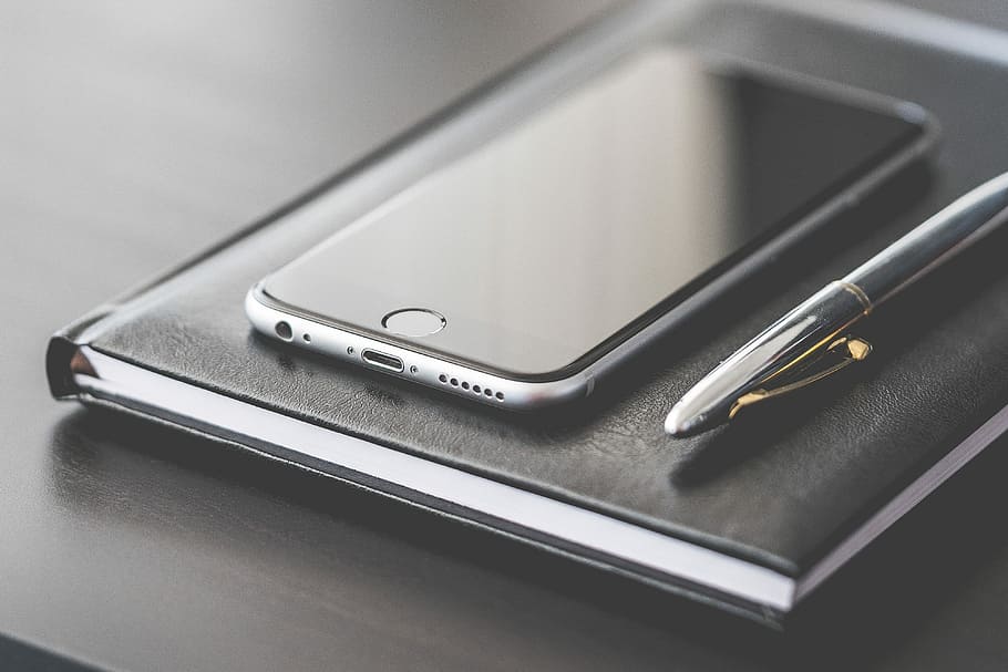 Business Gear: Smartphone, Silver Pen and Diary, black, business man
