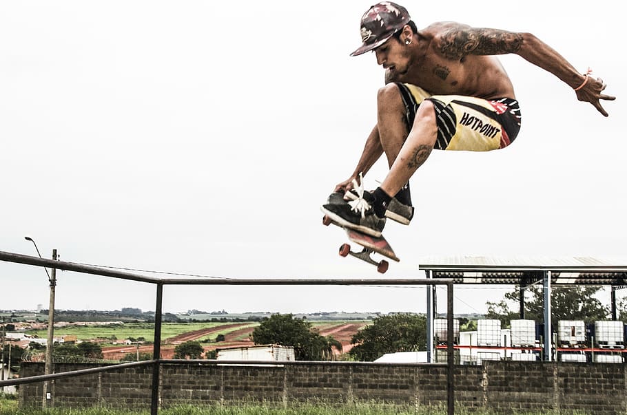 man doing skateboard tricks under white sky, sport, fly, radical, HD wallpaper