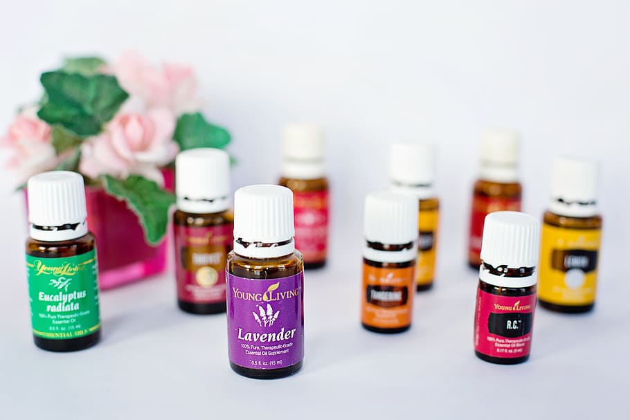 shallow focus photography of assorted bottles, essential oils