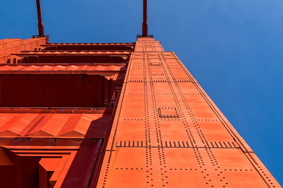 structural shot of red building, low-angle photography of orange architectural structure HD wallpaper