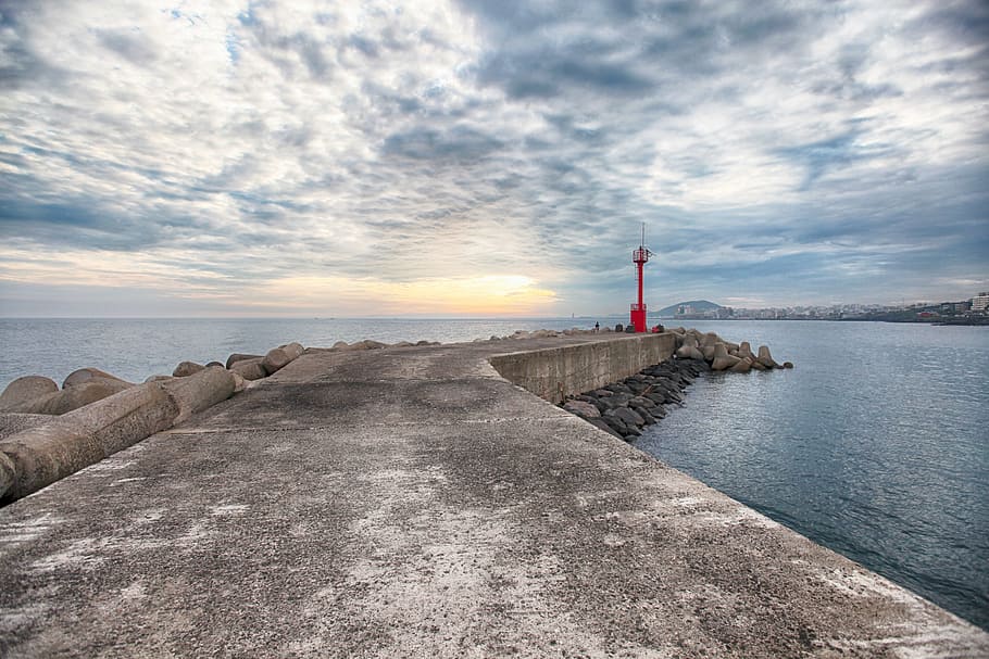 landscape photography of lighthouse on seawall under cloudy sky, HD wallpaper