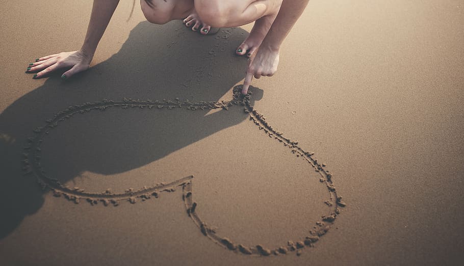 person drawing heart shape on sand, bare, beach, break, calm