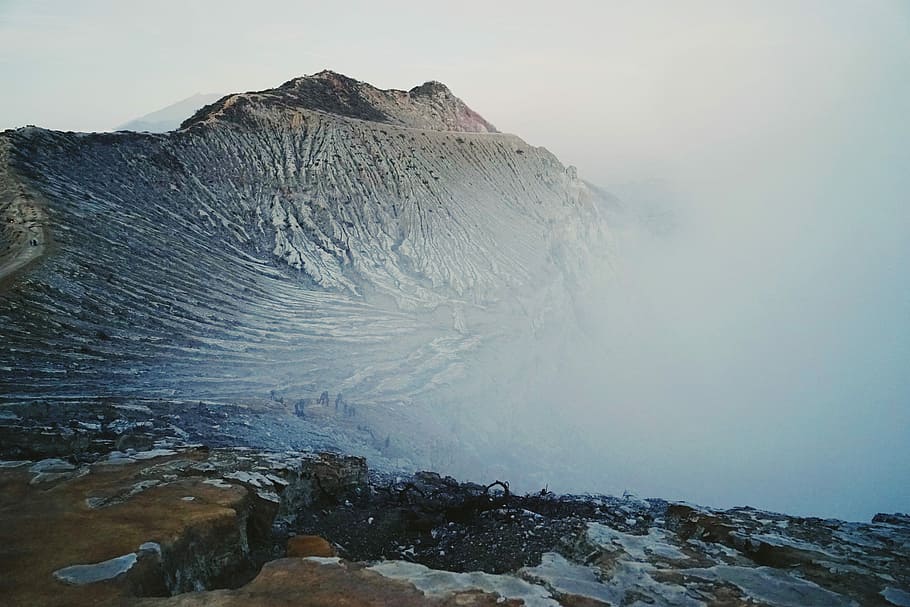 mountain peak during daytime, aerial photography of brown mountain surrounded by white cloud HD wallpaper
