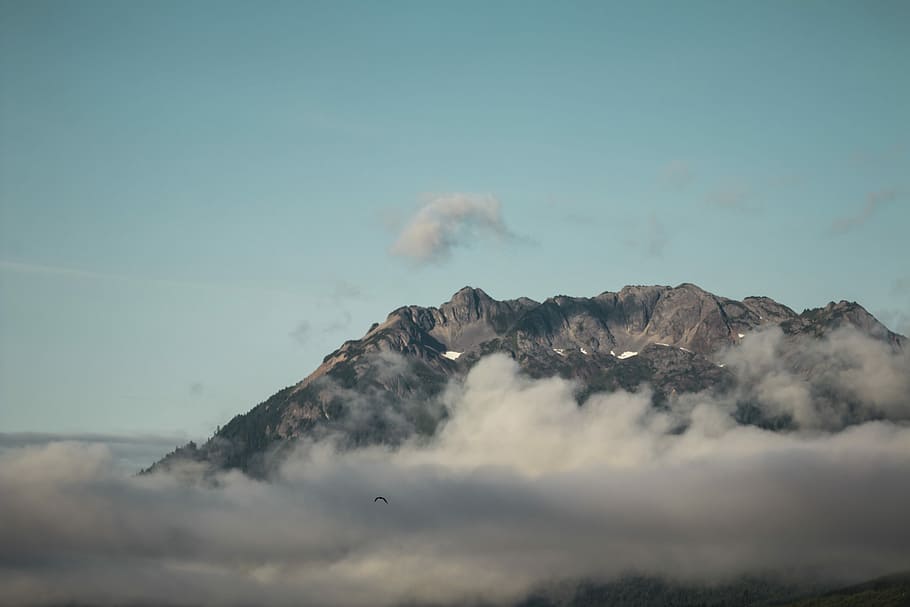 mountain photo during daytime, brown mountain covering with clouds HD wallpaper