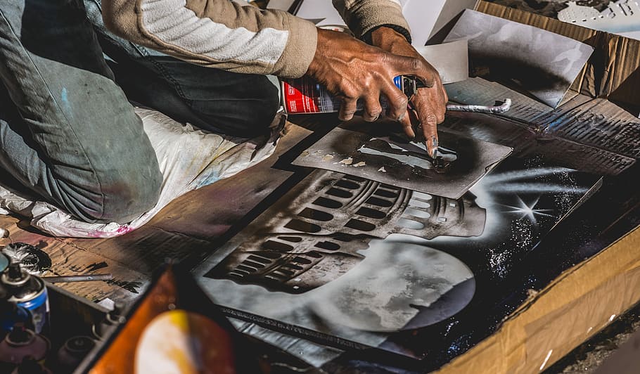 person left index finger pointing on a concrete building printed photo on top of a table HD wallpaper