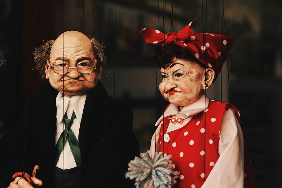 closeup photo of two man and woman puppets, puppet show, grandma