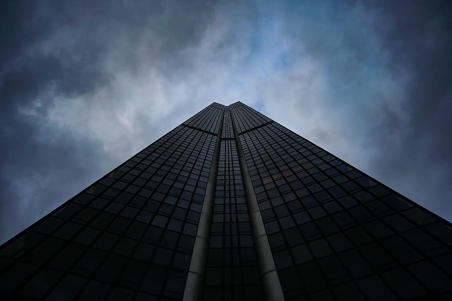low-angle photography of black concrete building with glasses under cloudy sky, low-angle photography of high-rise building under cloudy sky HD wallpaper