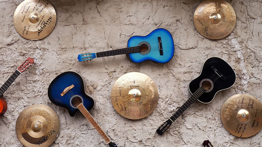 three assorted-color acoustic guitars surrounded with cymbals HD wallpaper