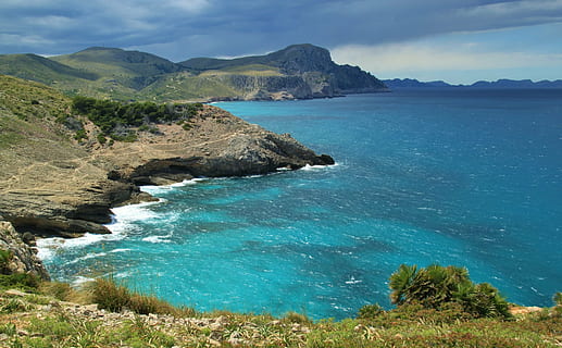 brown mountain beside body of water at daytime, sea, wave, clouds HD wallpaper