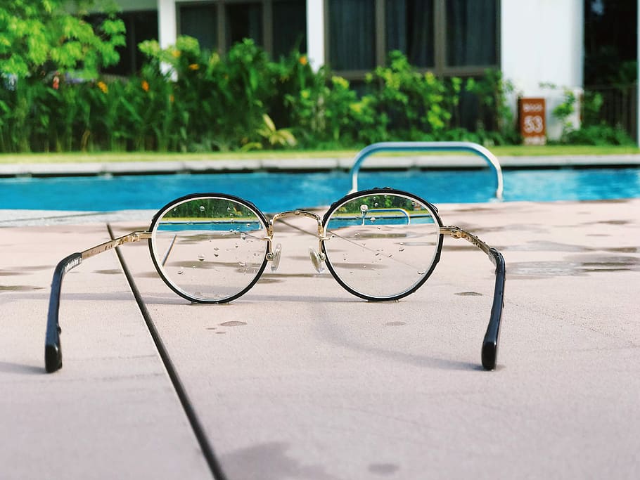 eyeglasses with black frames on white fabric, black framed eyeglasses near swimming pool at daytime HD wallpaper