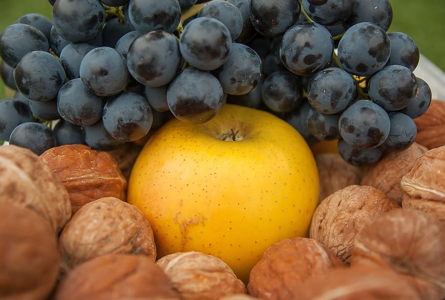 grapes on round yellow fruit surrounded by walnuts, nuts apple HD wallpaper