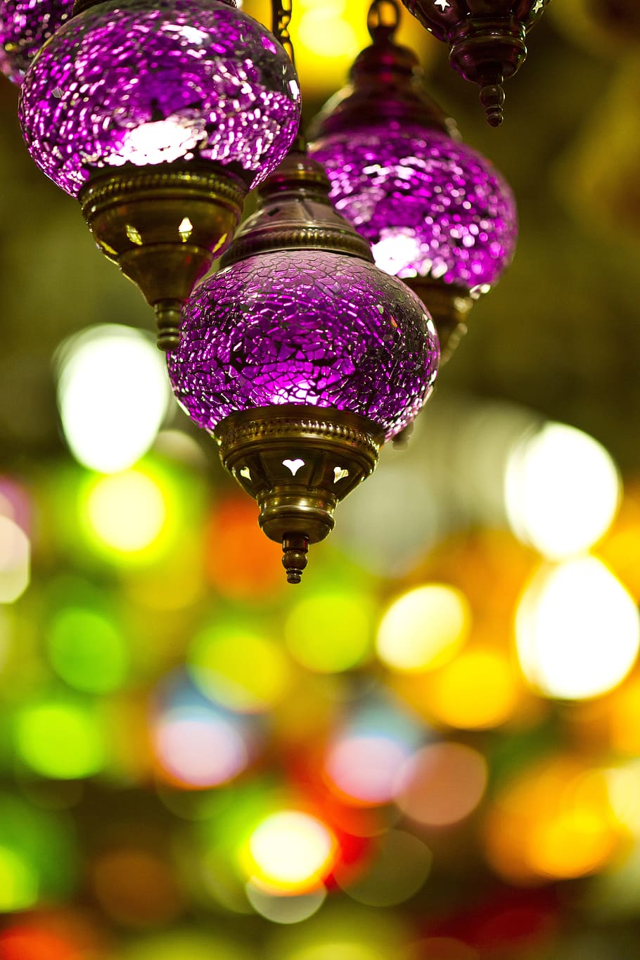 focus photography of three purple hanging decor with bokeh background