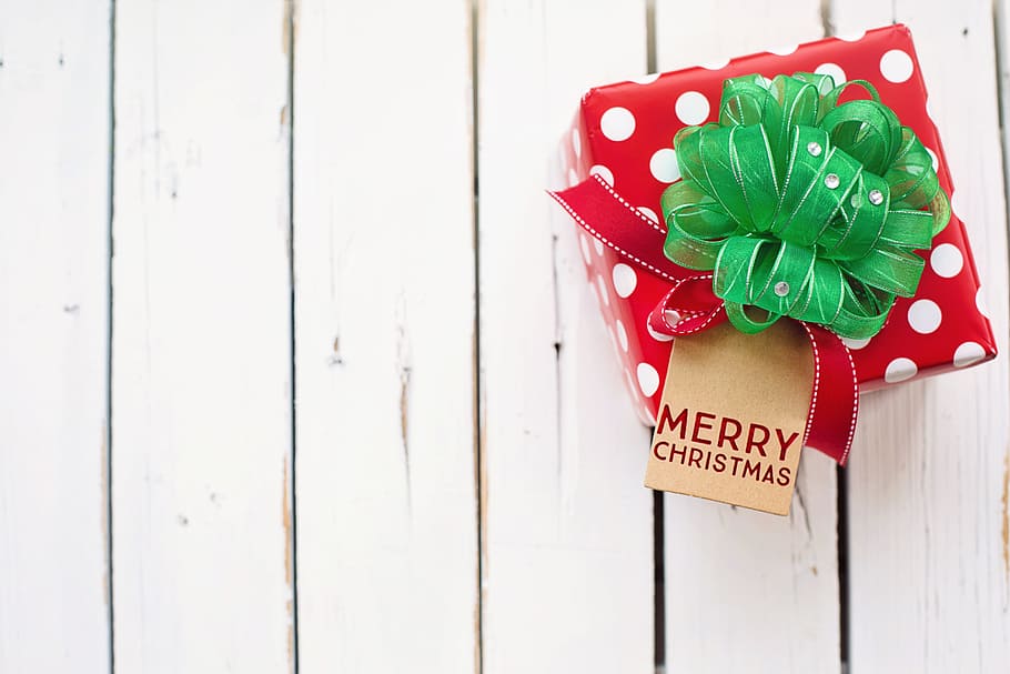 red and white polka-dot Merry Christmas gift box on white wood board floor HD wallpaper