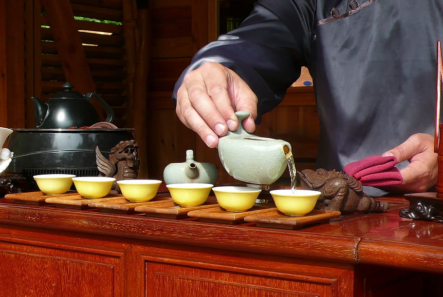 six round yellow ceramic bowls and two grey teapots, man, hands HD wallpaper