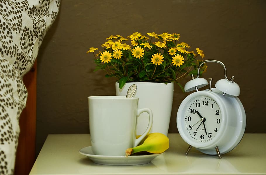 white alarm clock and white ceramic mug on top of white table HD wallpaper