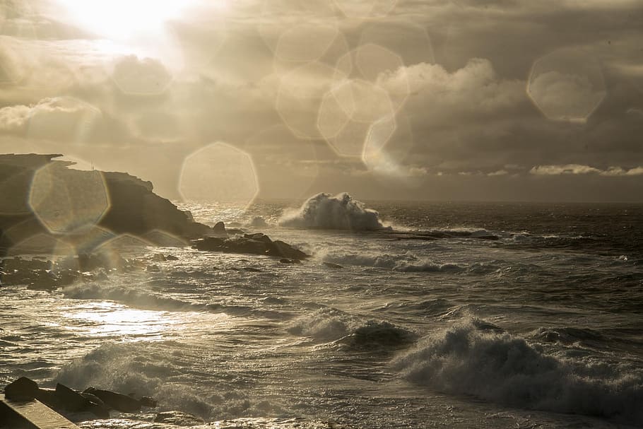 sea wave near rocks under grey sky at sunset, clovelly, sydney