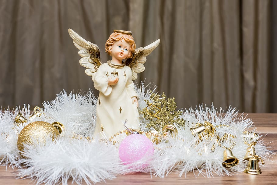 cherub figurine near bauballs, christmas presents, happy new year 2018