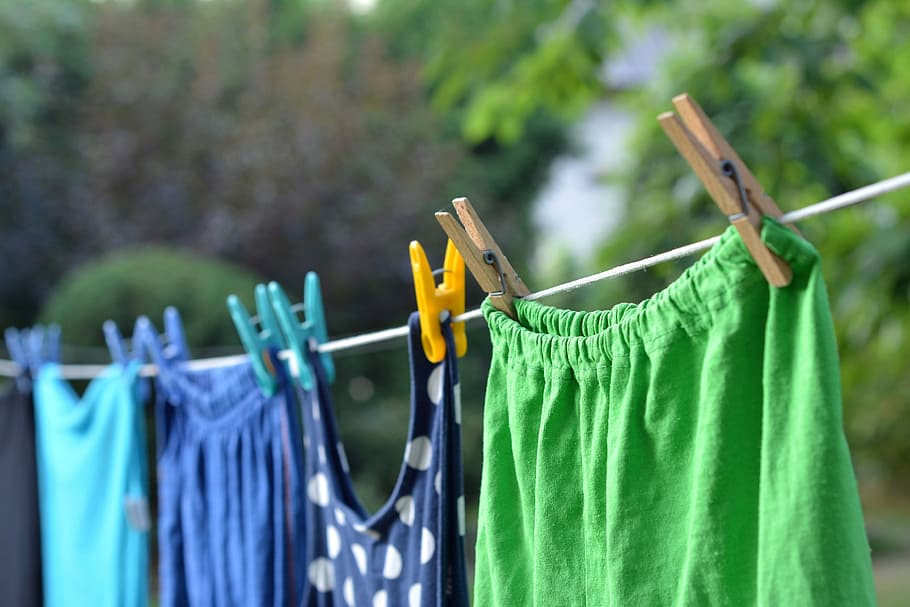 selective focus photography of apparels clipped on rope outdoors during daytime