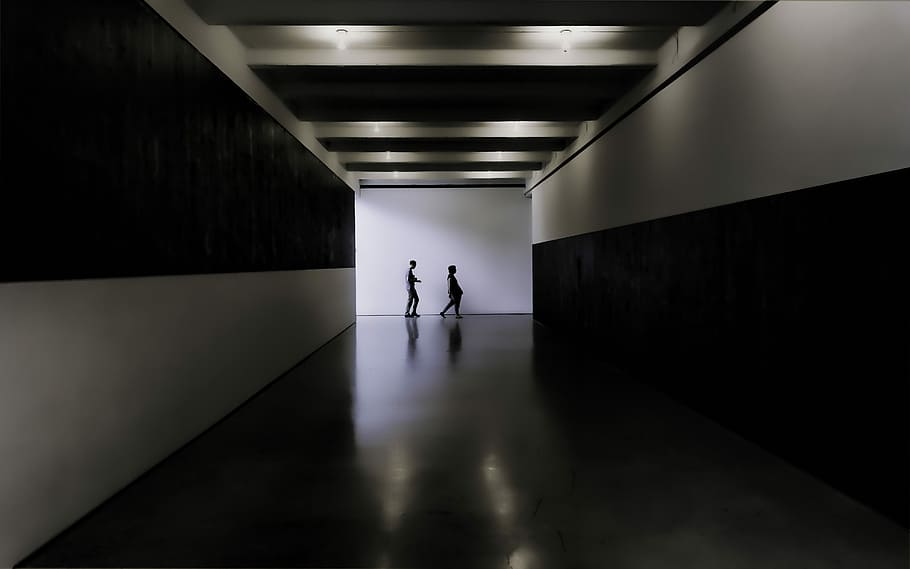 two persons walking towards white and black building, two person standing near wall HD wallpaper