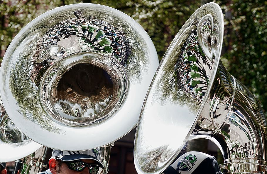 two men playing trombones, brass band, reflections, tuba, sousaphone
