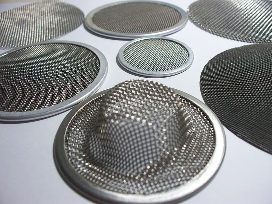 round gray steel screens on white surface, filter, technology