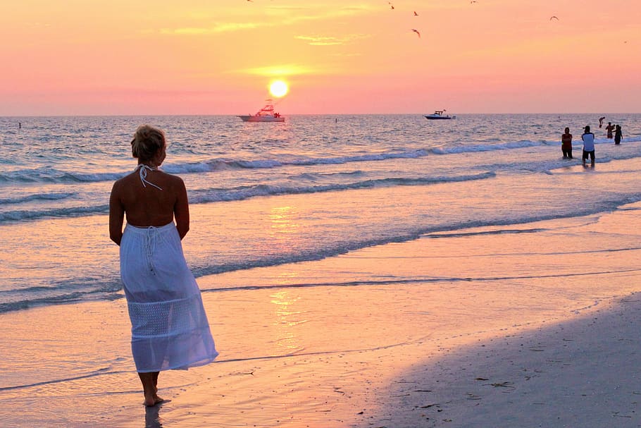woman standing beside seashore, pretty girl, sunset, vacation