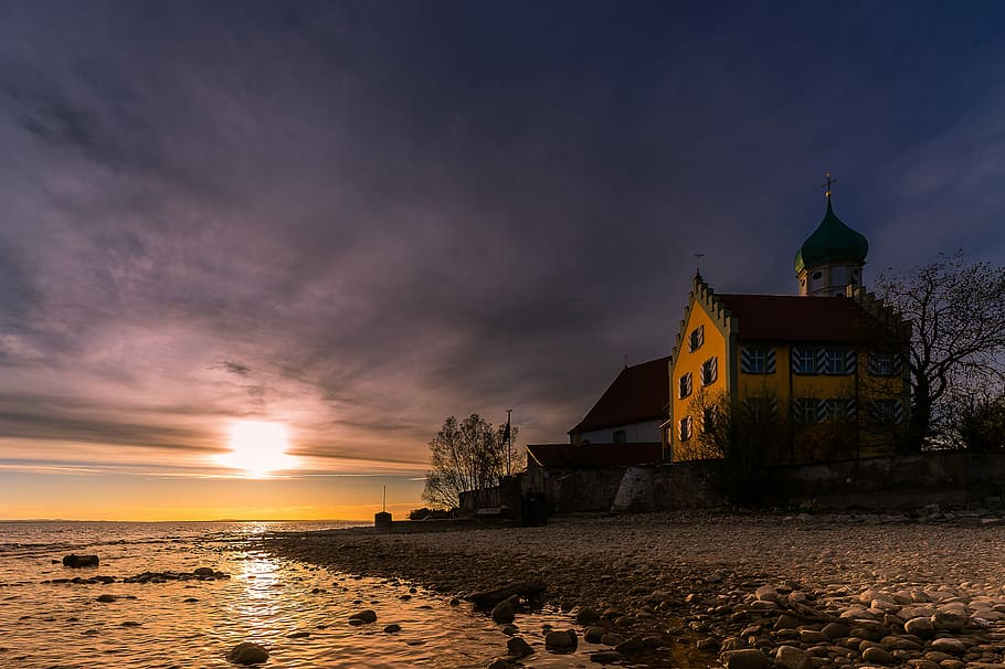 house on seashore under cloudy sky, sunset, waters, dusk, castle HD wallpaper
