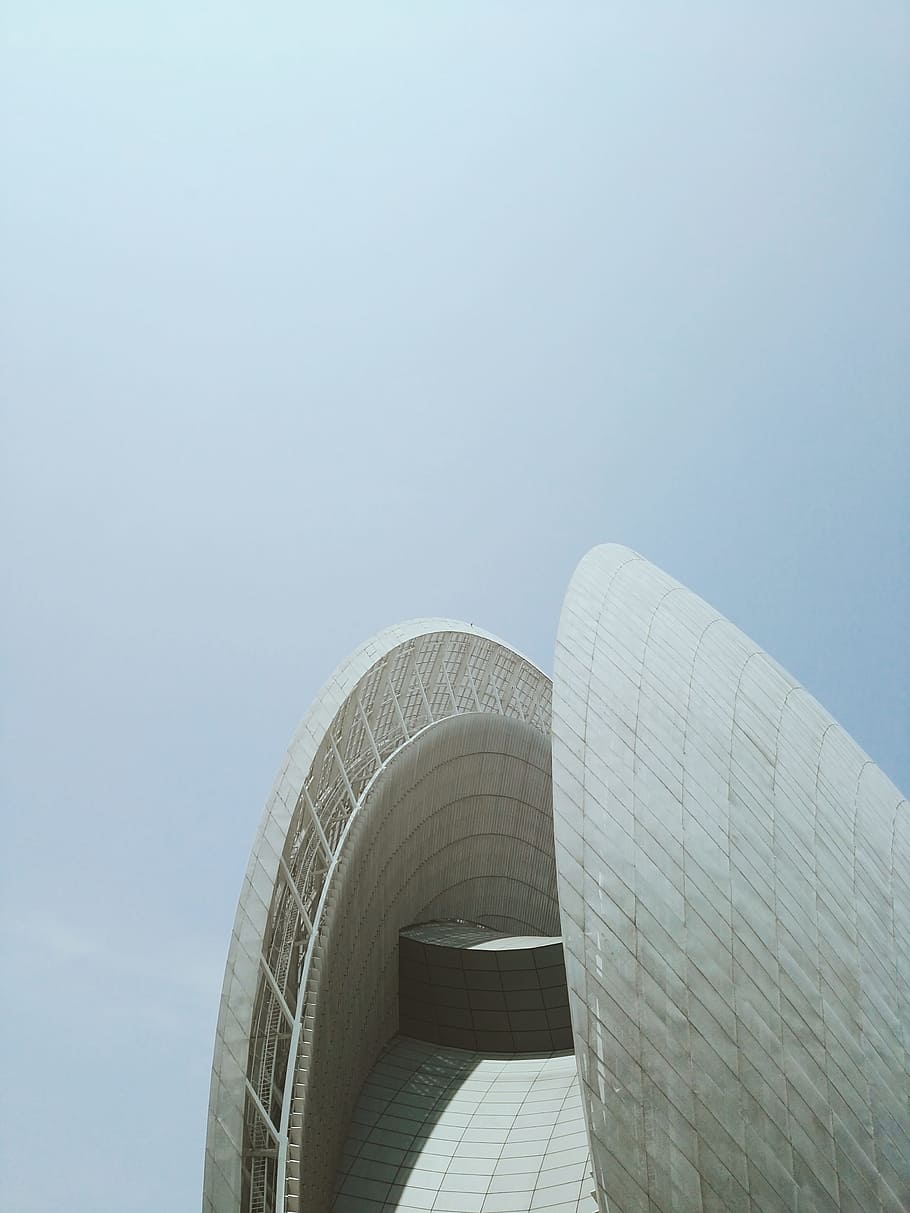 concrete building under white clouds, white concrete building under gray sky at daytime HD wallpaper