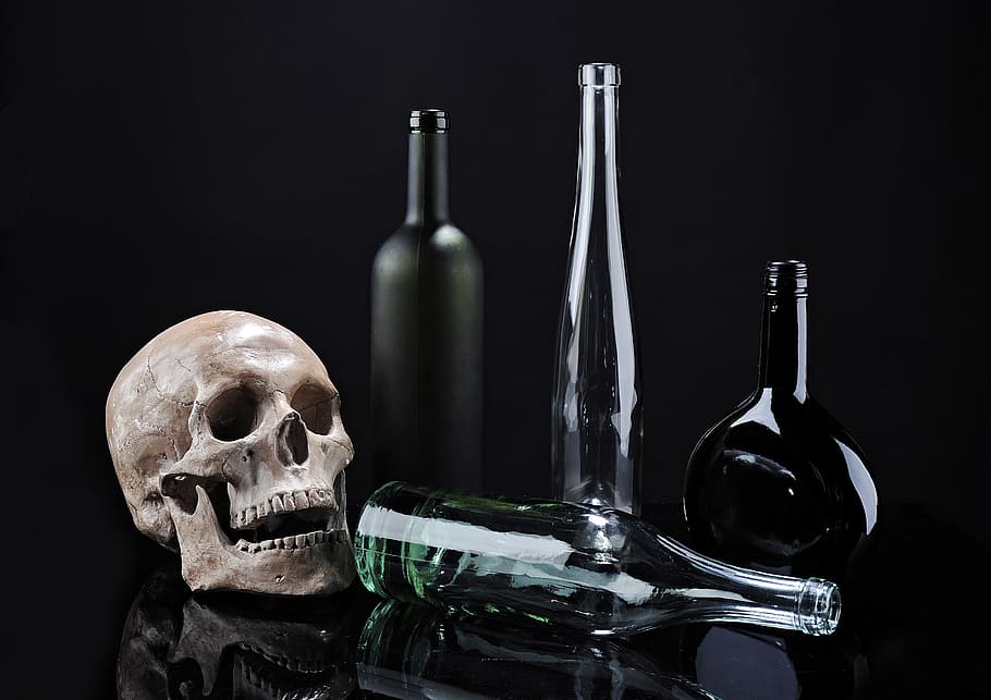 skull beside clear glass bottle, skeleton, contrast, composition HD wallpaper