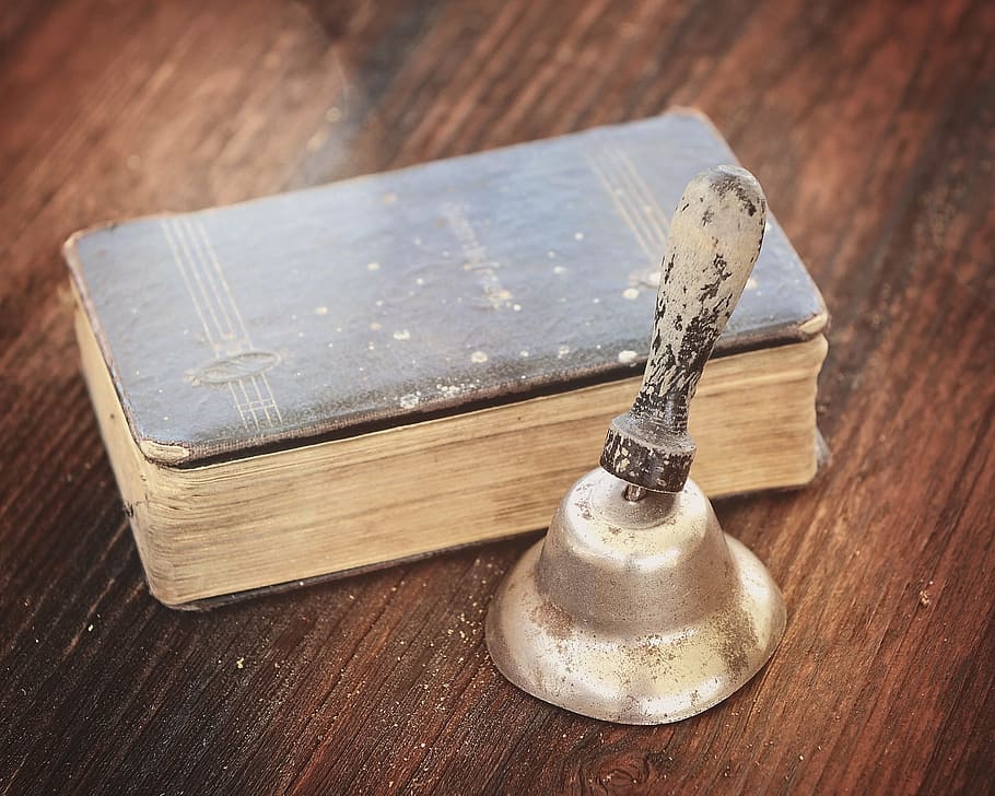 gray handbell beside bible, book, old, old book, prayer book HD wallpaper